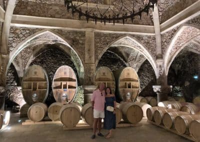 French Riviera Wine Tours - Couple enjoying a wine tour in Côtes de Provence, posing in the cellar of Font du Broc